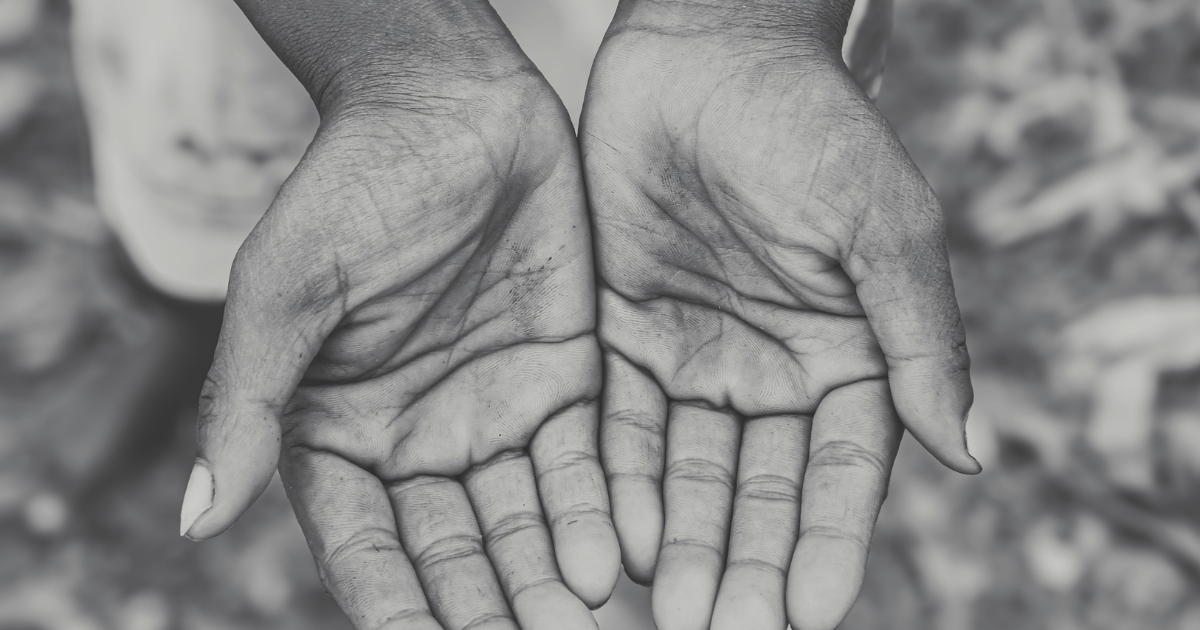 a black and white photo of two hands